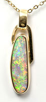 18k gold pendant with a crystal pipe opal
